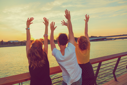 Friends Throwing Their Hands in the Air