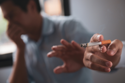 Person Offering a Cigarette