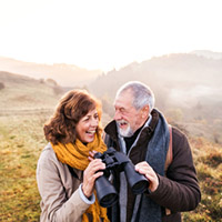 Man and Woman Looking Through Binoculars