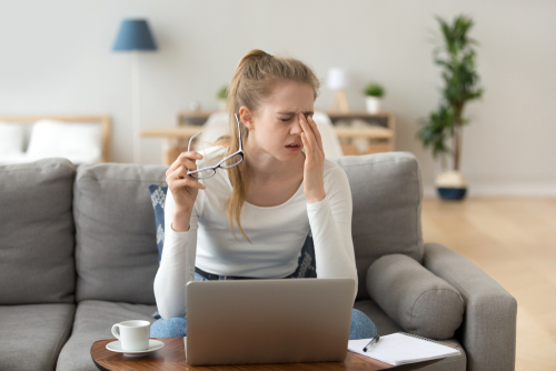 Young woman suffering from dry eyes