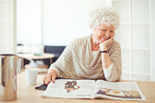 Senior woman reading magazine