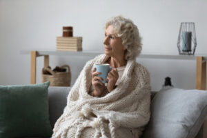 woman on a couch with a coffee mug