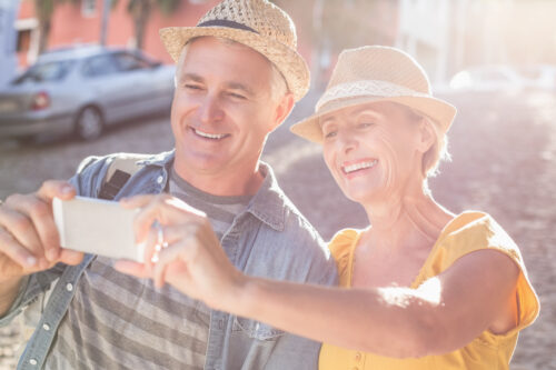 Senior couple enjoying outdoors taking selfie