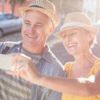 Senior couple enjoying outdoors taking selfie