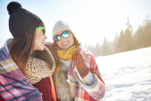 Young woman in snow with friend