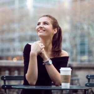 Hopeful woman drinking coffee