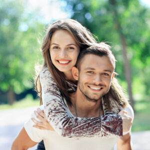 Young couple outdoors smiling